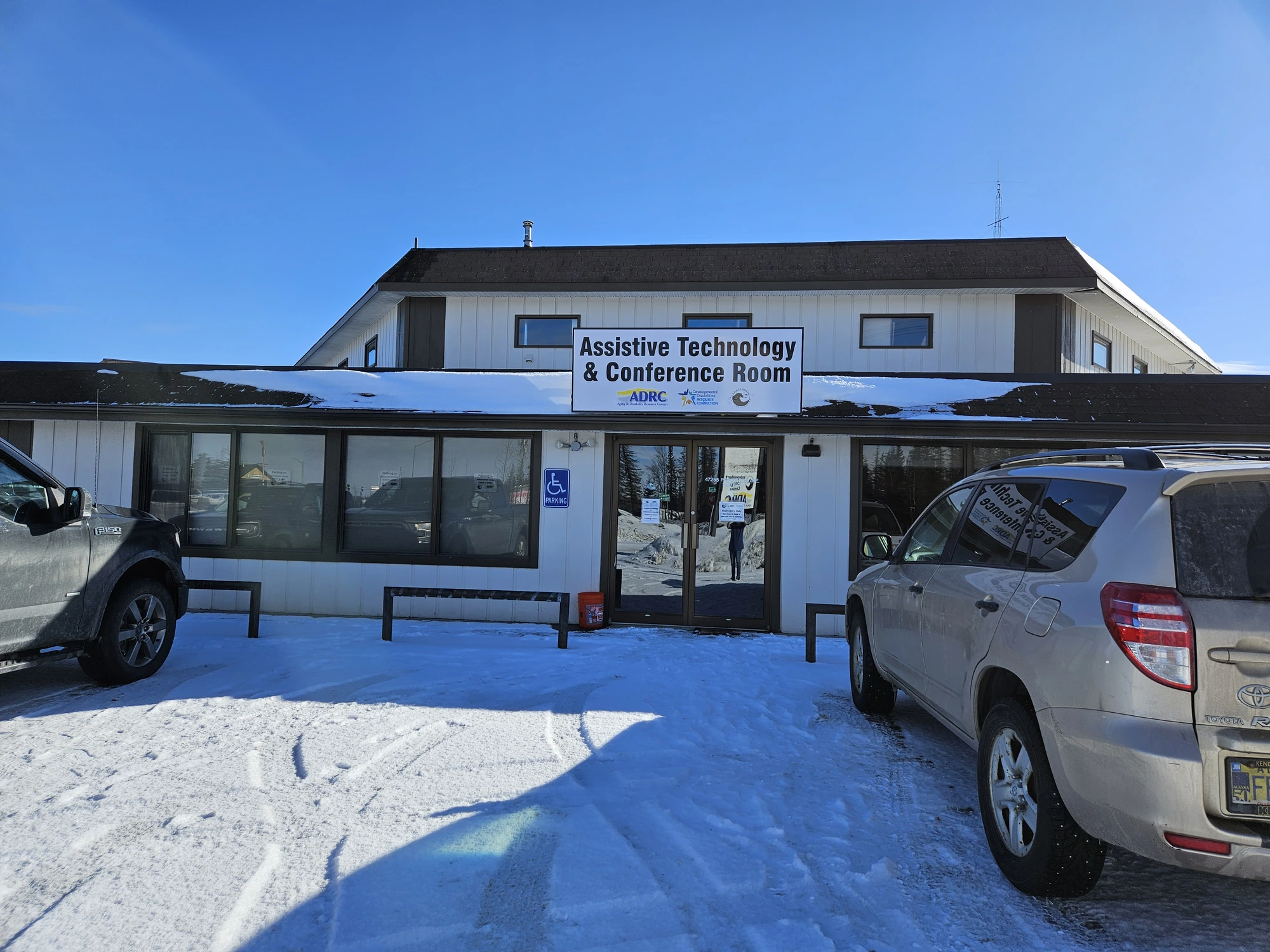 The Soldotna office for ILC, a black-and-white building with a sign that reads 'Assistive Technology & Conference Room'.