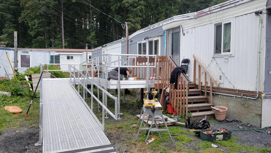 Mobile home with a new accessible ramp under construction.